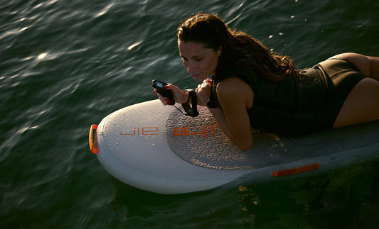 A woman starts prone on a Fliteboard eFoil